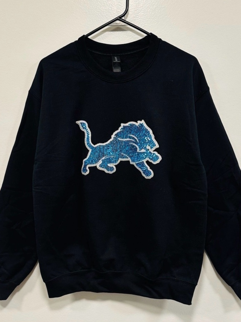 NFL Black Crewneck Sweatshirt with Blue Lion Patch